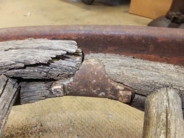 ANTIQUE TRUCK WHEEL WITH IRON RIM AND WOODEN SPOKES