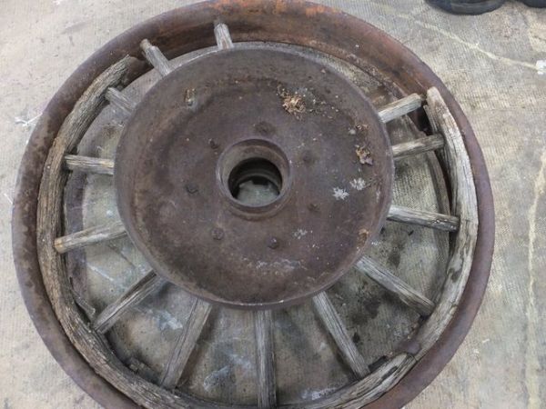 ANTIQUE TRUCK WHEEL WITH IRON RIM AND WOODEN SPOKES