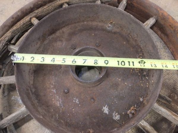 ANTIQUE TRUCK WHEEL WITH IRON RIM AND WOODEN SPOKES