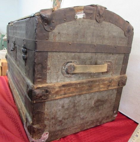 ANTIQUE HUMPBACK STEAMER TRUNK WITH STAMPED TIN EXTERIOR
