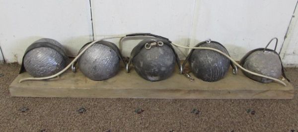 FIVE LEAD BALL WEIGHTS & A METAL FORM