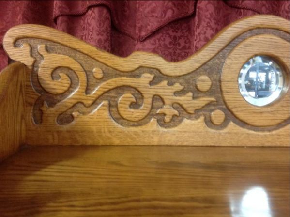 ANTIQUE OAK BOOKCASE WITH CARVED TOP, BEVELED MIRROR & DRAWER 