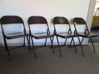 FOUR BROWN METAL FOLDING CHAIRS