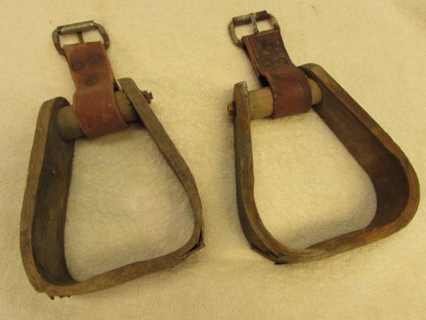 A PAIR OF WOOD STIRRUPS WITH LEATHER STRAPS