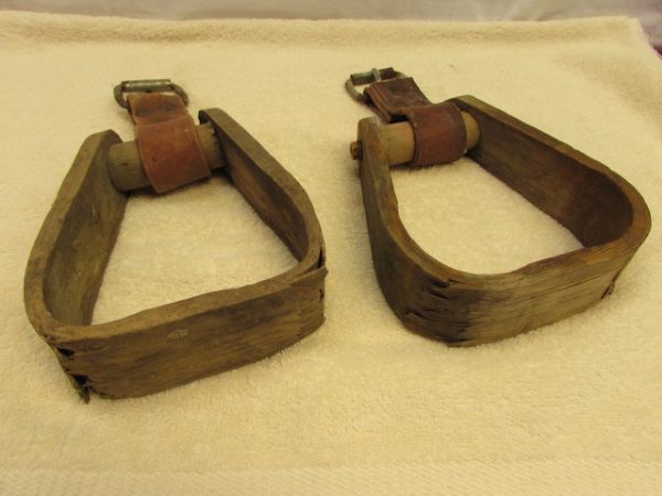 A PAIR OF WOOD STIRRUPS WITH LEATHER STRAPS