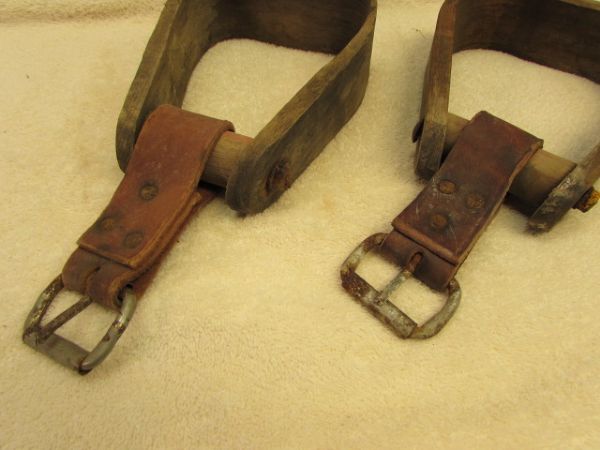 A PAIR OF WOOD STIRRUPS WITH LEATHER STRAPS