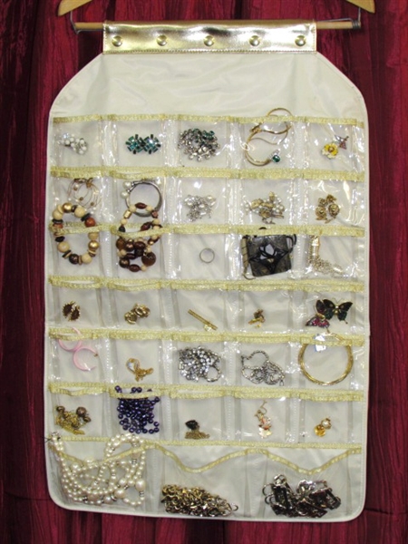 A PIRATE'S BOOTY OF VINTAGE COSTUME JEWELRY WITH HANGING DISPLAY STORAGE