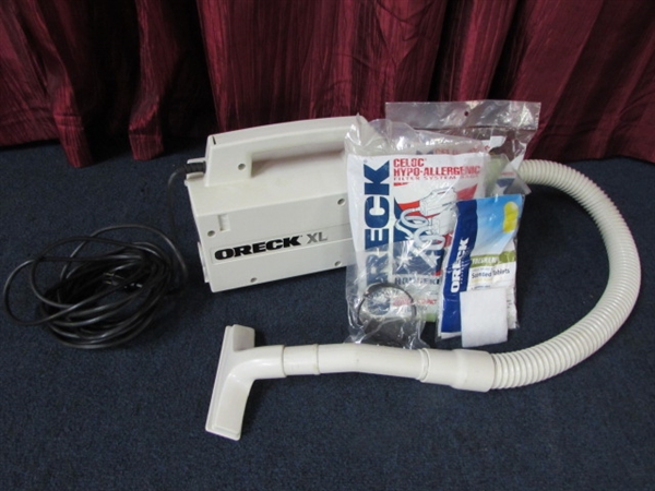 FOR QUICK CLEAN UPS THE ORECK XL COMPACT COMMERCIAL HAND HELD VACUUM WITH ATTACHMENT & BAGS