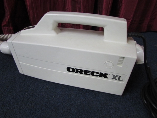 FOR QUICK CLEAN UPS THE ORECK XL COMPACT COMMERCIAL HAND HELD VACUUM WITH ATTACHMENT & BAGS