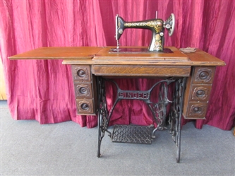 ANTIQUE SINGER "REDEYE" SEWING MACHINE IN TREADLE WITH OAK CABINET - 7 DRAWERS