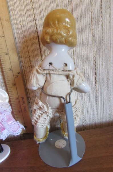 SMALL KEWPIE DOLL & 2 SMALL PORCELAIN DOLLS WITH STANDS