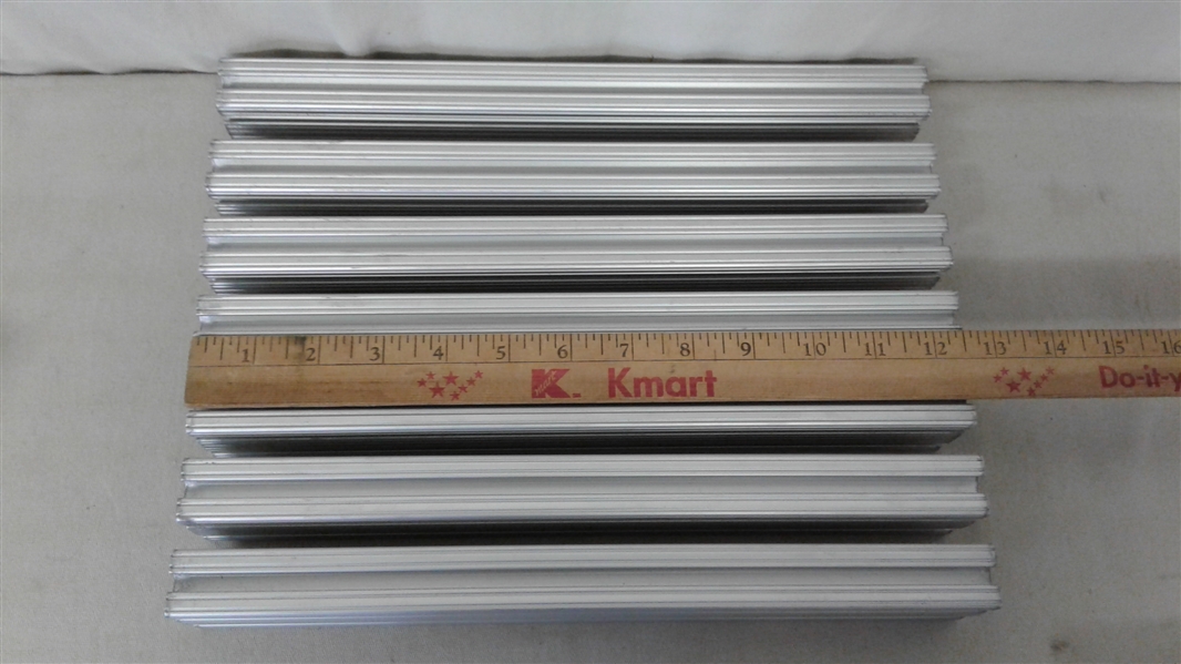 ASSORTED SIZES OF GROOVED ALUMINUM FRAMING EXTRUSIONS