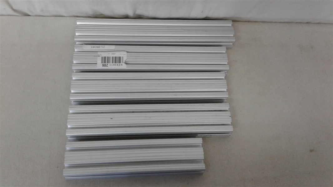 ASSORTED SIZES OF GROOVED ALUMINUM FRAMING EXTRUSIONS