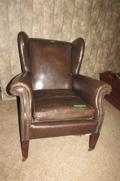 ANTIQUE NAUGAHYDE CHAIR WITH FRONT WHEELS