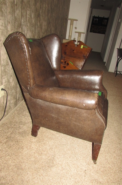 ANTIQUE NAUGAHYDE CHAIR WITH FRONT WHEELS