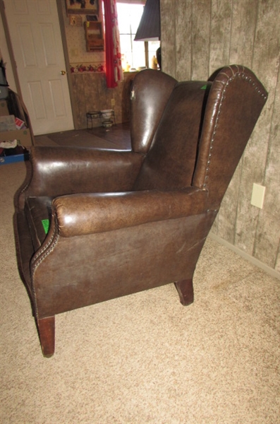 ANTIQUE NAUGAHYDE CHAIR WITH FRONT WHEELS