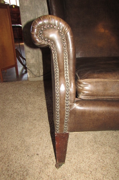 ANTIQUE NAUGAHYDE CHAIR WITH FRONT WHEELS