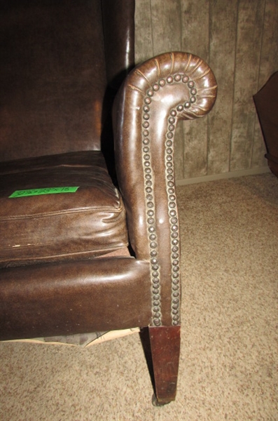 ANTIQUE NAUGAHYDE CHAIR WITH FRONT WHEELS