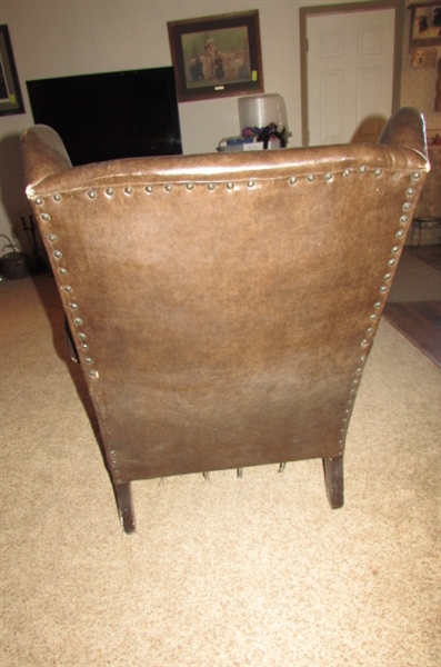 ANTIQUE NAUGAHYDE CHAIR WITH FRONT WHEELS