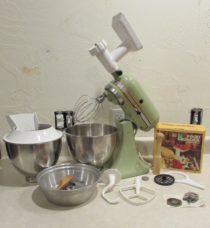 VINTAGE KITCHEN AIDE WITH FOOD GRINDER AND OTHER ATTACHMENTS