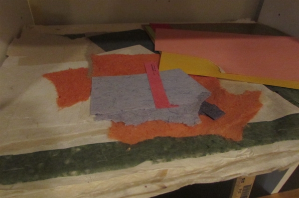 LARGE SHEETS OF HANDMADE PAPER AND OTHER COLORED STORE BOUGHT PAPER AND A HANDMADE DRAWING BOARD