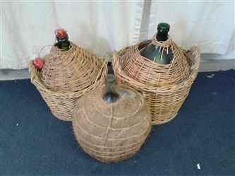 3 Vintage Demijohns In Baskets