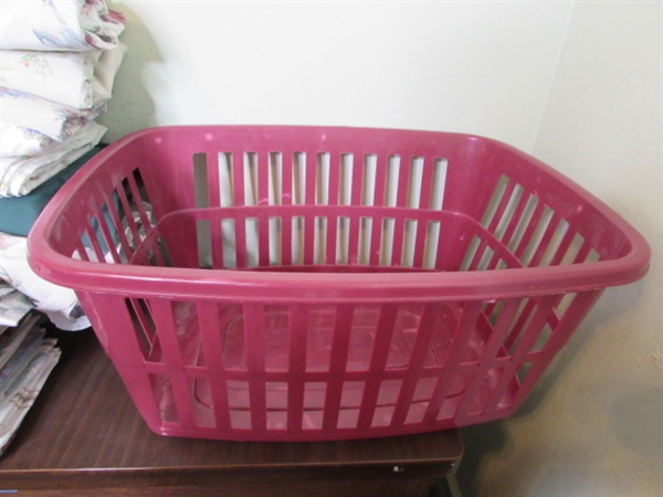 Assorted Sheets and Pillow Cases in Laundry Basket