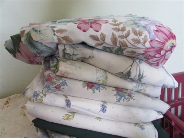 Assorted Sheets and Pillow Cases in Laundry Basket