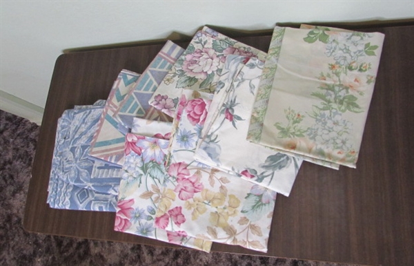 Assorted Sheets and Pillow Cases in Laundry Basket