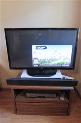 42" TV, OAK STAND, SOUND BAR AND DVD/VHS PLAYER