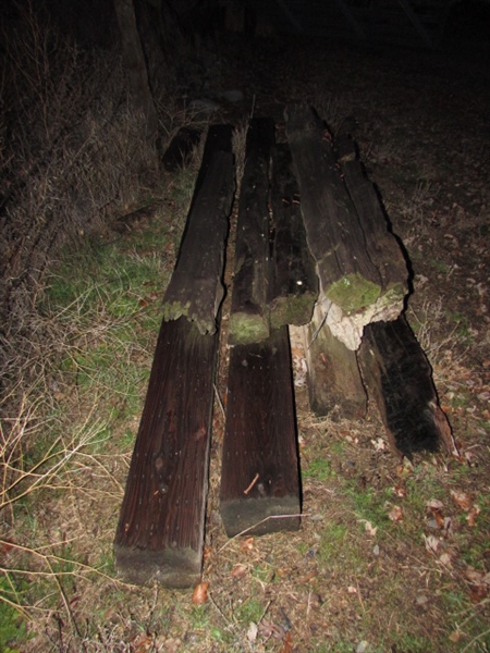 SMALL PILE OF WOOD FENCE POSTS
