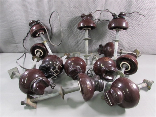 A DOZEN BROWN CERAMIC INSULATORS WITH POSTS