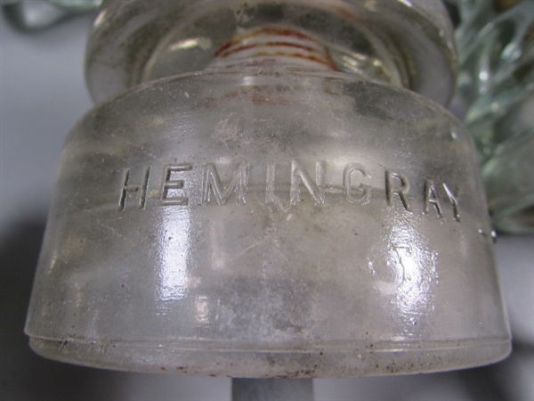 11 CLEAR GLASS HEMINGRAY INSULATORS ON POSTS