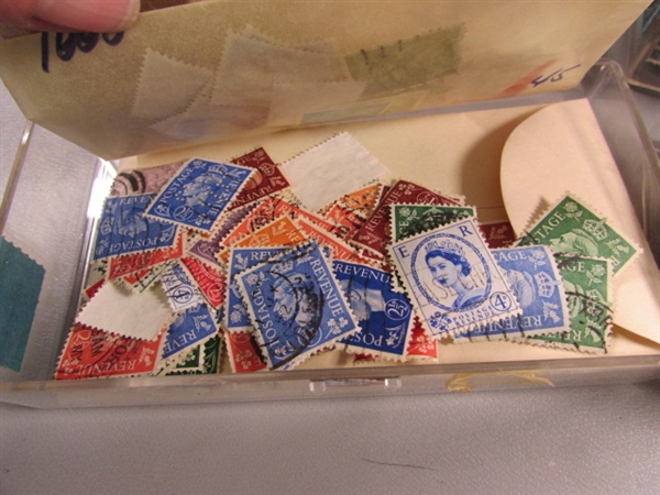 6 SMALL PLASTIC BOXES W/ASSORTED LOOSE POSTAGE STAMPS FOR COLLECTORS