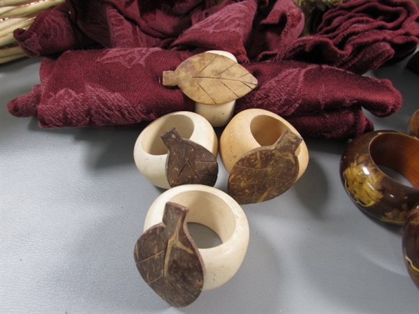 CARVED WOODEN NAPKIN RINGS, CLOTH NAPKINS & A BASKET