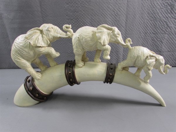 ELEPHANTS MARCHING ON TUSK STATUE - RESIN