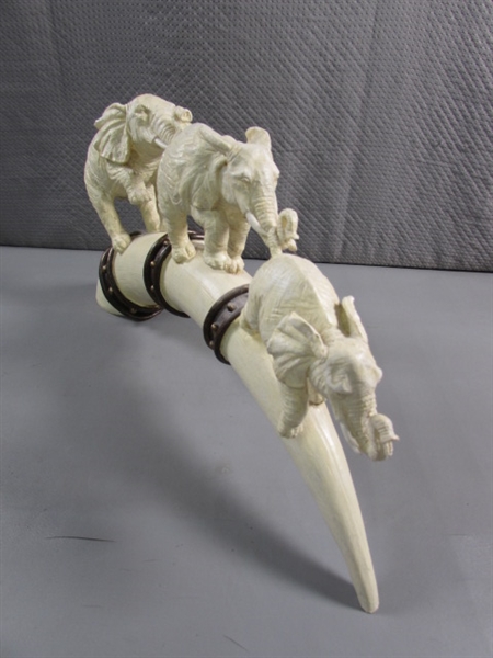 ELEPHANTS MARCHING ON TUSK STATUE - RESIN