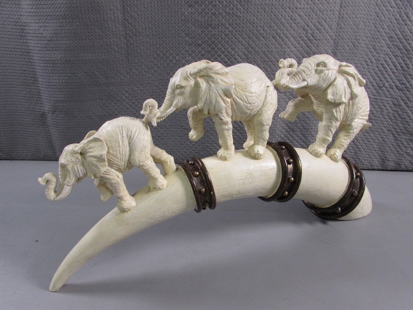 ELEPHANTS MARCHING ON TUSK STATUE - RESIN