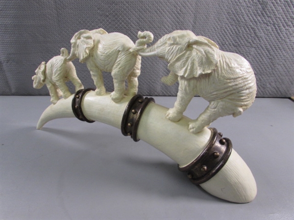 ELEPHANTS MARCHING ON TUSK STATUE - RESIN