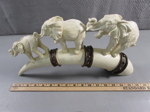 ELEPHANTS MARCHING ON TUSK STATUE - RESIN