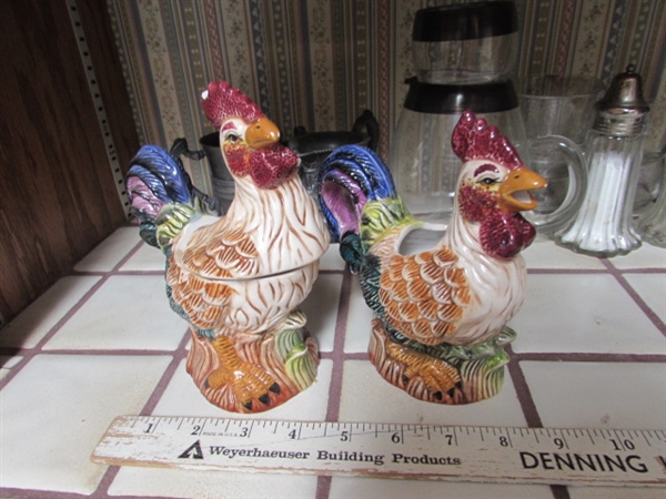 VINTAGE SILVERPLATE CREAMER, SALT & PEPPER SHAKERS, CERAMIC ROOSTERS, BRASS BULL HEAD SKEWERS & VINTAGE ROLY POLY GLASS PITCHER W/ONE GLASS